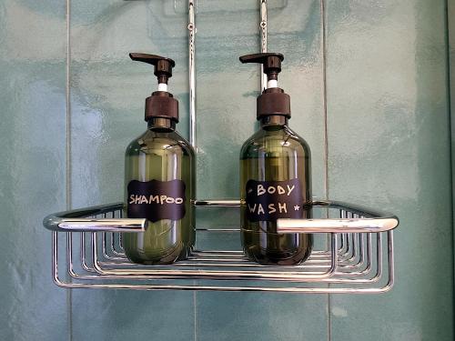 two glass bottles are hanging on a rack at HERON Apartment in Scardovari