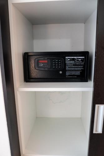 a microwave oven sitting on a shelf in a closet at Piscadera Harbour Village in Willemstad
