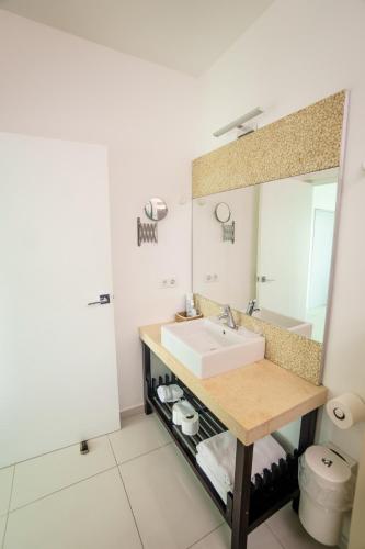 a bathroom with a sink and a mirror at Piscadera Harbour Village in Willemstad