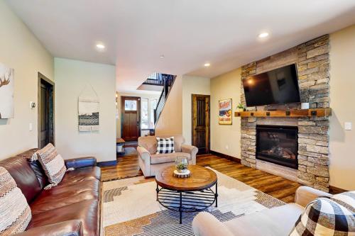 a living room with a couch and a fireplace at Pooewin Place in South Lake Tahoe