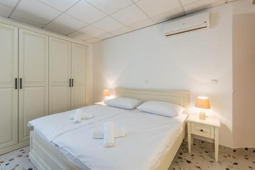 a bedroom with a white bed with two towels on it at Old Town Rooms Matusko in Split