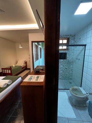 a bathroom with a shower and a toilet in a room at Porto Abraão Pousada in Abraão