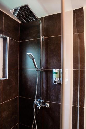 a shower with a shower head in a bathroom at Piscadera Harbour Village in Willemstad