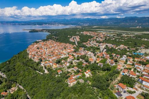 an aerial view of a city next to the water at Apartmani Vila Mara M 4 heated pool and whirpool in Omišalj