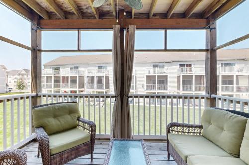 a screened in porch with two chairs and a couch at Rehoboth Crossing 19915 Ames Dr in Rehoboth Beach