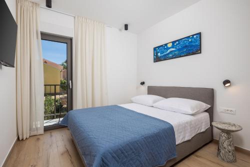a bedroom with a bed and a large window at Apartmani Vila Mara M 4 heated pool and whirpool in Omišalj