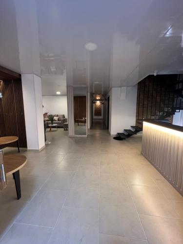 an empty lobby with tables and chairs in a building at Hotel Fenix in Ocaña