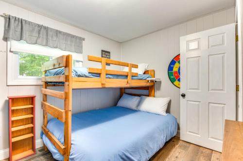 a bedroom with two bunk beds and a door at Quiet New Hampshire Getaway with Game Room! in Center Barnstead