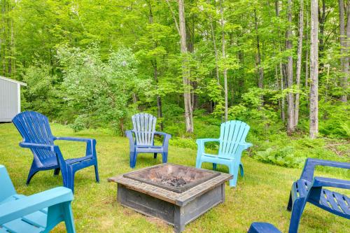 a group of blue chairs sitting around a fire pit at Quiet New Hampshire Getaway with Game Room! in Center Barnstead