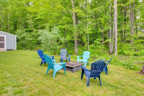 four blue chairs and a table in a yard at Quiet New Hampshire Getaway with Game Room! in Center Barnstead