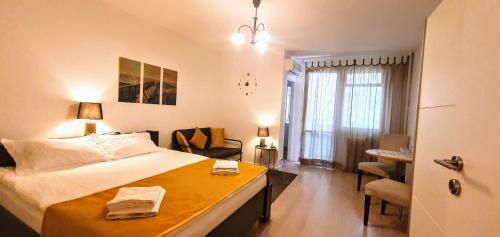 a bedroom with a large bed and a desk in it at City break Park Studio Bucharest in Bucharest