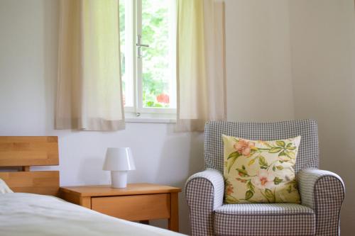 a bedroom with a chair and a window at Ferienhaus Koglegg in Wies