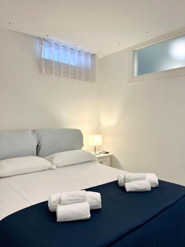 a bedroom with a bed with two towels on it at Luxury Villa Relax in Ischia Town