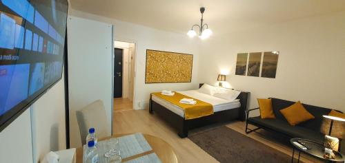 a small room with a bed and a couch at City break Park Studio Bucharest in Bucharest