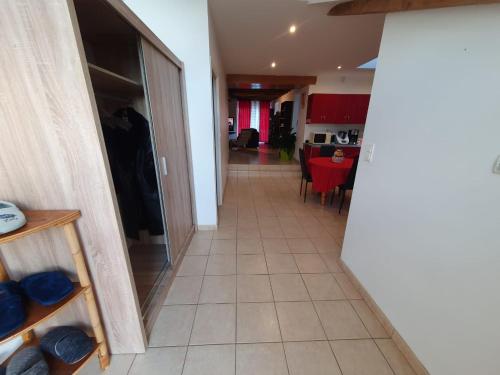 a hallway with a dining room and a living room at Brocéliande calme breton, spa, wifi, amazon-disney tv, 4 lits, Freebox revolution,draps, café, thé in Guer