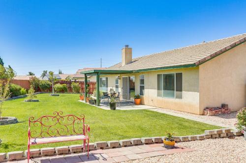 a red bench sitting in front of a house at Victorville Home with Large Yard and Charcoal Grill! in Victorville
