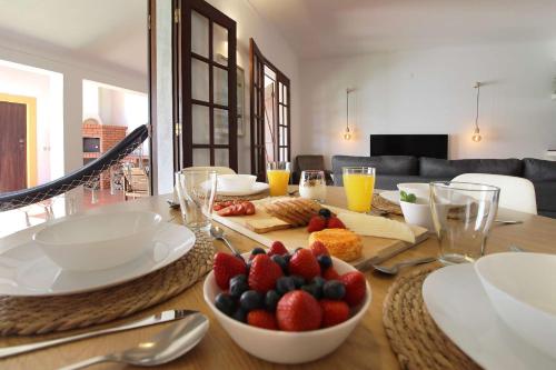 a table with a bowl of fruit on top of it at Casa do Altinho in Vila Nova de Milfontes