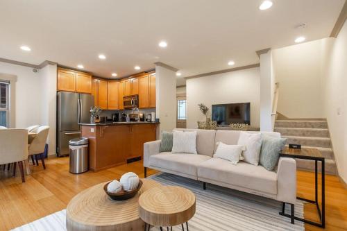 a living room with a couch and a kitchen at Perch - City Oasis in Seattle