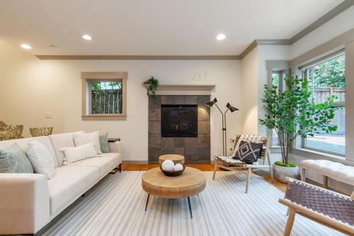 a living room with a white couch and a fireplace at Perch - City Oasis in Seattle