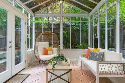 an open conservatory with a wicker chair and a wicker chair at Perch - City Oasis in Seattle