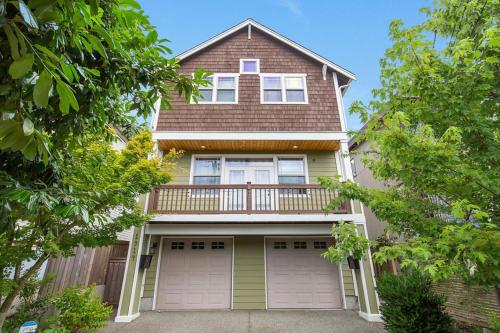 a house with a balcony and two garage doors at Perch - City Oasis in Seattle