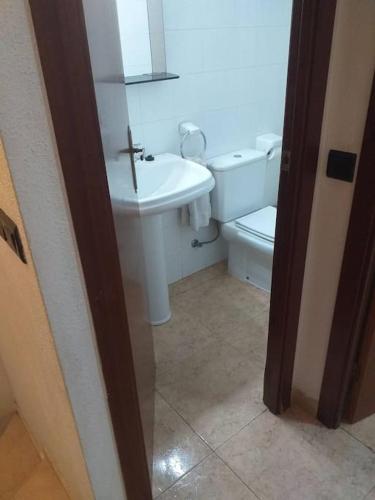 a bathroom with a white sink and a toilet at Casa en Malgrat, cerca de la playa in Malgrat de Mar