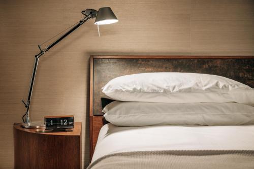 a bedroom with a bed with a lamp next to it at Otis Harbor Springs in Harbor Springs