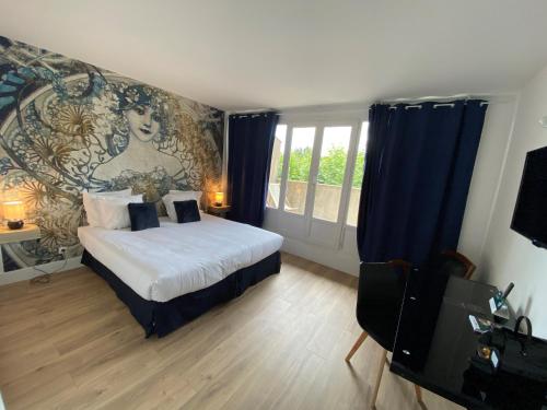 a bedroom with a bed and a painting on the wall at Logis Hôtel Médiéval, Montélimar Nord in Rochemaure
