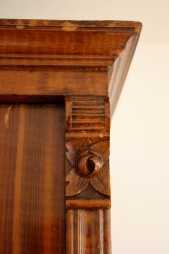 a wooden grandfather clock with a flower on it at Ferienhaus Koglegg in Wies