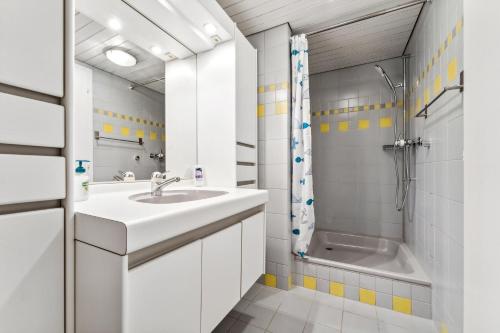 a white bathroom with a sink and a shower at App. Seeblick Top of Interlaken in Beatenberg