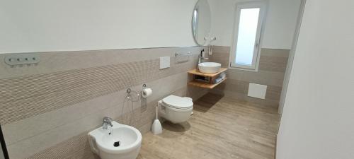 a bathroom with a toilet and a sink at Agriturismo Sa Pramma in Santa Maria la Palma
