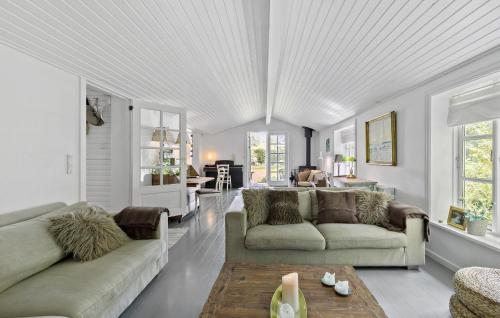 a living room with two couches and a table at Lovely Home In Vejby With Kitchen in Vejby