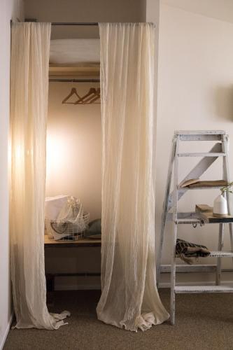 a white curtain in a room with a ladder at Hotel Cervetta 5 in Modena