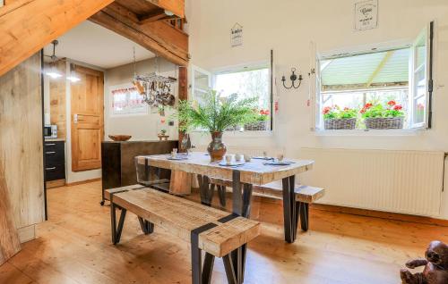 a dining room with a table and a bench at Awesome Home In Alette With Wifi in Alette