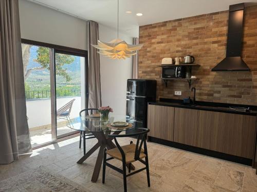 a kitchen with a glass table and a dining room at CASA YANGUAS APARTAMENTOS RURALES EN LAUJAR DE ANDARAx in Laujar de Andarax
