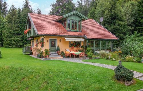 a small yellow house with a red roof at Nice Home In Bayerisch Eisenstein in Regenhütte
