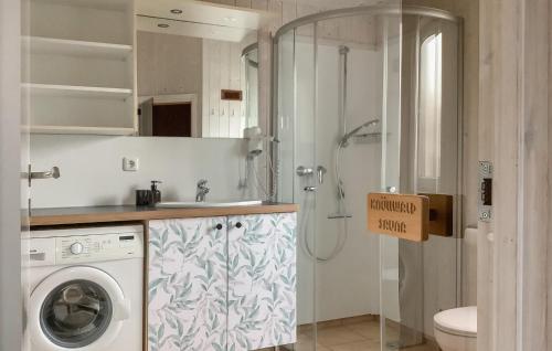 a bathroom with a shower and a washing machine at Freibeuterweg 23 - Dorf 5 in Travemünde