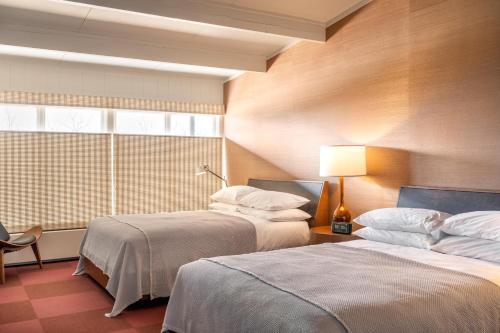 a hotel room with two beds and a window at Otis Harbor Springs in Harbor Springs
