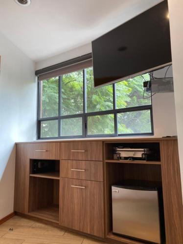 a large entertainment center with a flat screen tv at Suites del Valle in Mexico City