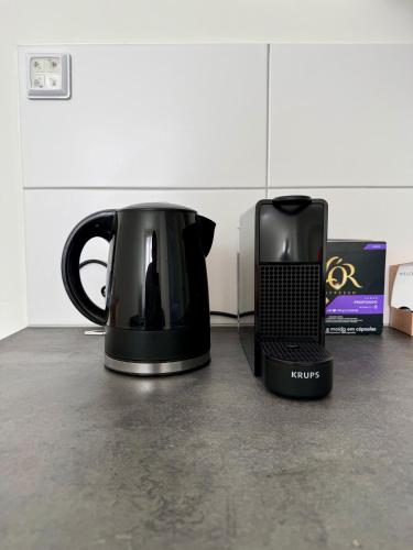 a black coffee pot sitting on top of a counter at 86 3City Appartement met Privé parkeerplaats in Enschede
