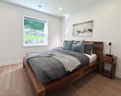 a bedroom with a wooden bed with a window at Le domaine du Sous-Bois in Mont-Blanc