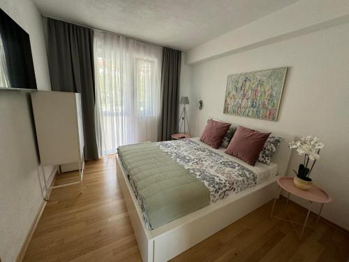 a bedroom with a large bed and a window at Apartman Vera in Brela