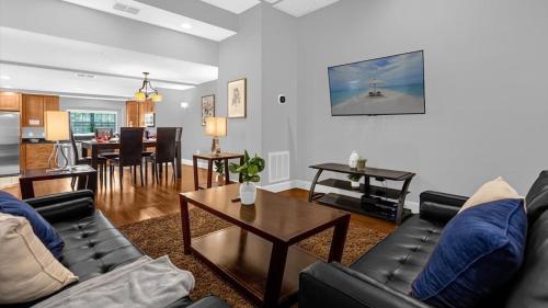 a living room with a couch and a table at Sunny Stay in FL - 4-Bedroom Townhome by Disney! in Orlando