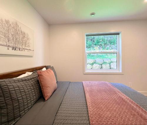 a bedroom with a bed and a window at Le domaine du Sous-Bois in Mont-Blanc