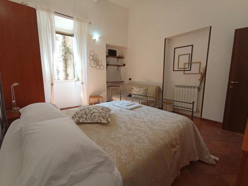 a bedroom with a bed and a window at al Vicolo Torlonia in Tivoli