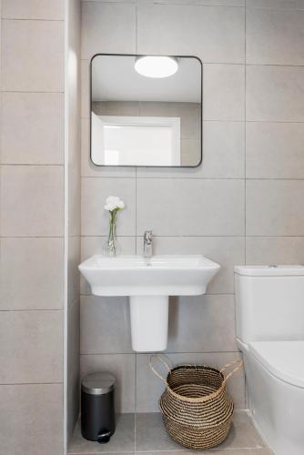 a bathroom with a sink and a mirror at Casa Luca - Luxury penthouse in Estepona