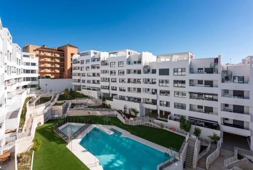 an aerial view of a building with a swimming pool at Casa Luca - Luxury penthouse in Estepona