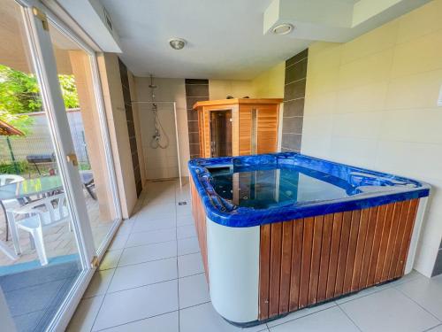 a large blue and white bath tub in a room at Relax Prémium Wellness Apartman in Siófok
