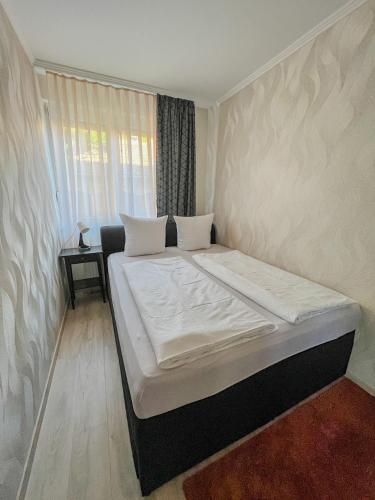 a large bed in a room with a window at Relax Prémium Wellness Apartman in Siófok