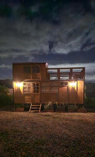 a train car sitting on the tracks at night at KUYAY in Ráquira